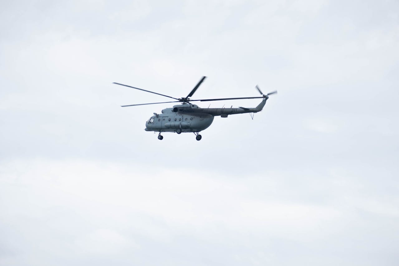 Military helicopter flying over a cloudy sky in Croatia, showcasing aerial dynamics.